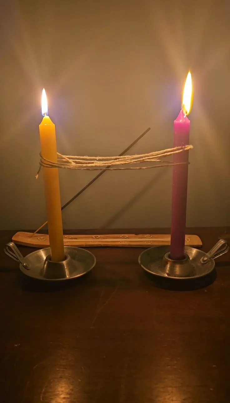 Ritual de corte de laços com duas velas unidas por um fio